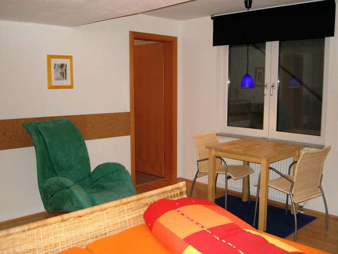 Zimmer mit Sessel und Tisch